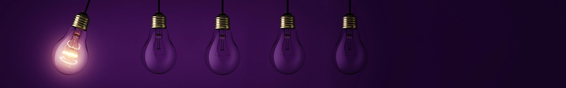 Row of hanging purple lightbulbs with one illuminated bulb symbolizing innovation and standout ideas.